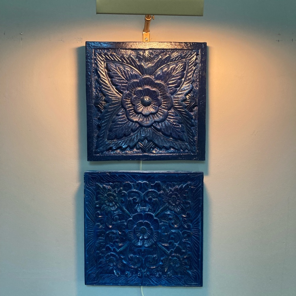 2 carved wood wall hangings of lotus flowers